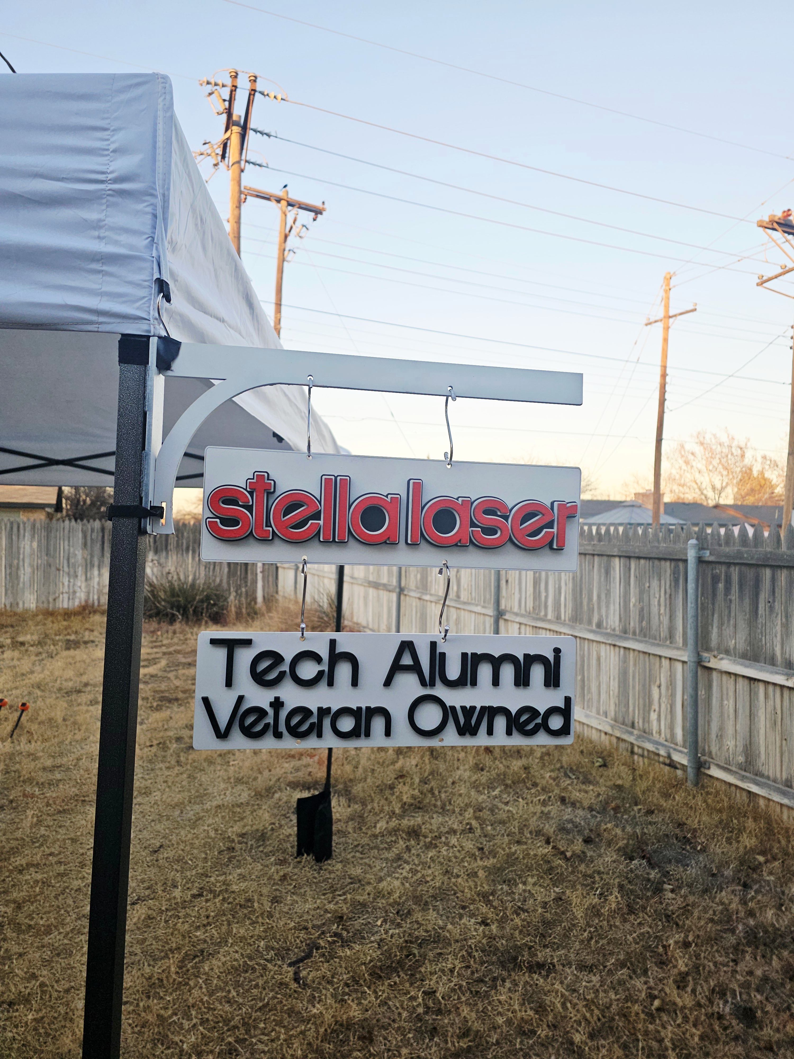 Craft fair canopy bracket holding hanging business sign made from laser cut wood